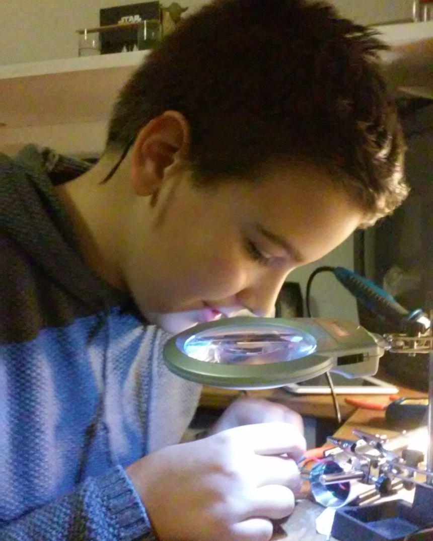 Eli soldering electronics as a kid in 2014