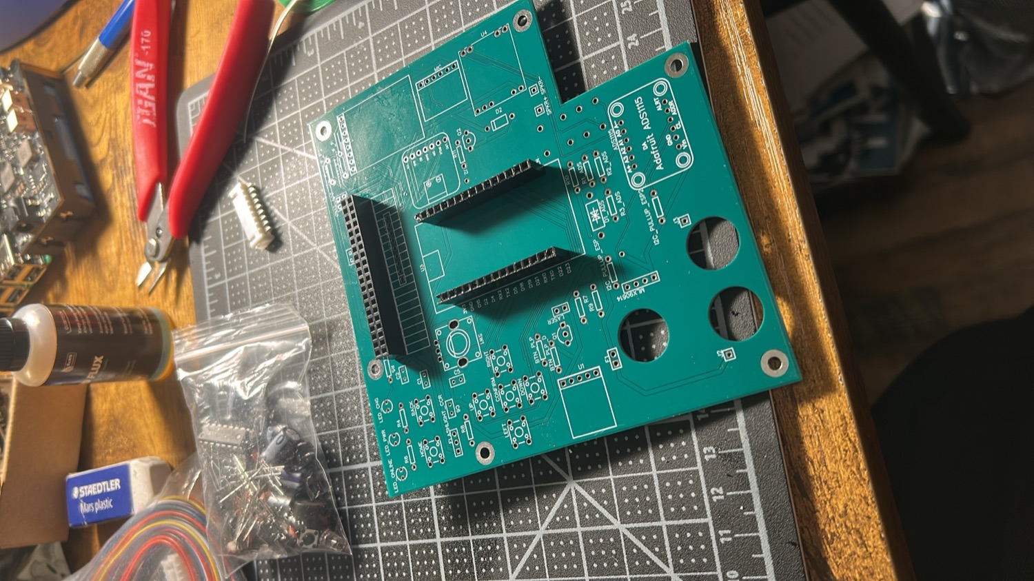 Bare fabricated carrier PCB on a cutting mat